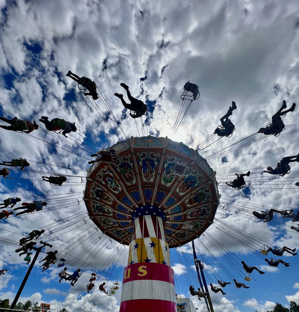 Into the Clouds - Nadine Freeman At the annual Mountain State Fair in Fletcher,  carnival-goers can experience thrilling rides, like The Swing Ride, which spins passengers high above the ground. {Amateur} @nadinehopefree