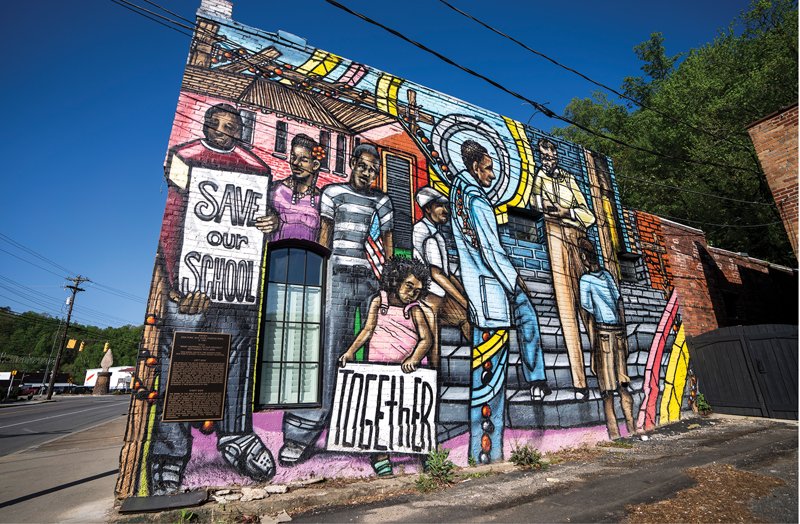 The mural depicts the 1955 attempt to enroll Black students in a segregated school in Old Fort.