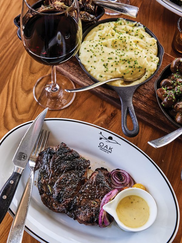 Steak served up with family-style sides of potatoes and mushrooms at Oak Steakhouse in the Skyline Lodge.