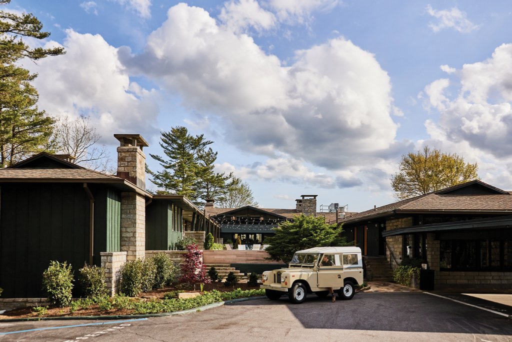 The vintage Land Rover at Skyline Lodge adds to the mid-century vibe. (Right) One of the soaring granite fireplaces in the lounge at Oak Steakhouse Highlands.