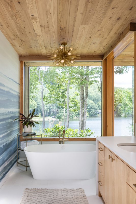 The primary bathroom features an ombre wall covering. The tonal nature is reflective of the lake, creating a serene, spa-like space.