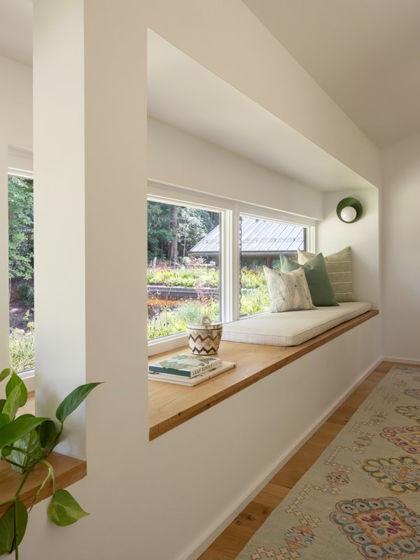 Even though it’s not facing the water, the view from this hallway window seat is stunning. It gazes onto the green roof and dahlia garden.