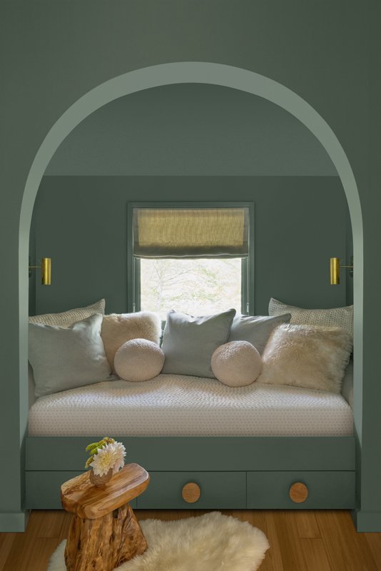 The bunk room has a more youthful color palette, although it still follows the home’s blue and green color scheme.
