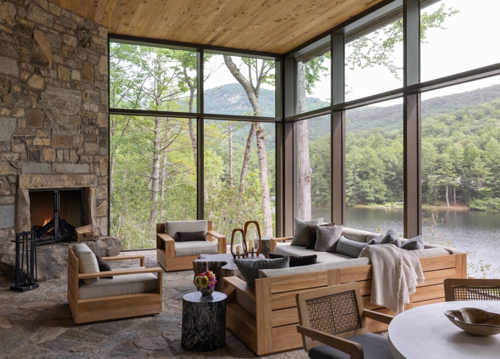 The large window walls are on full display from the back of the home, which overlooks Lake Cardinal, a private lake upstream from Lake Toxaway.