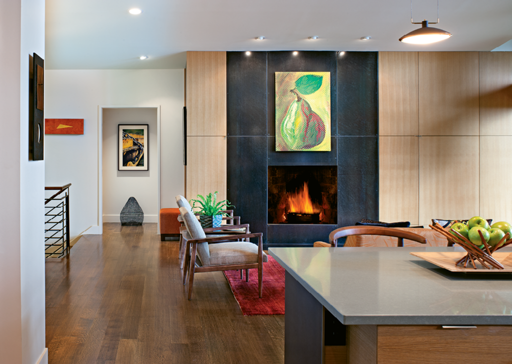 The fireplace was resurfaced with steel panels and white oak cabinets were added.