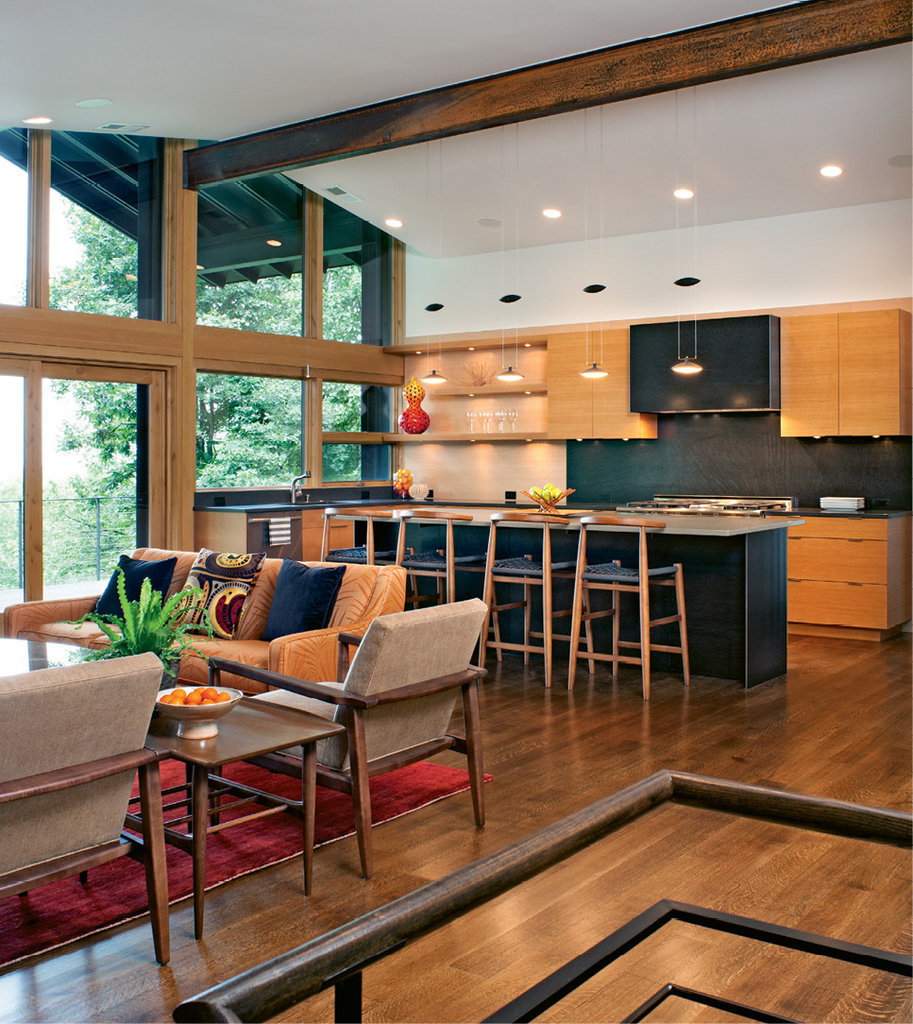 The configuration of the second floor changed to allow for an open kitchen, living, and dining area. New floor-to-ceiling windows brighten the modern space, and great care was taken to manage the transitions between materials.