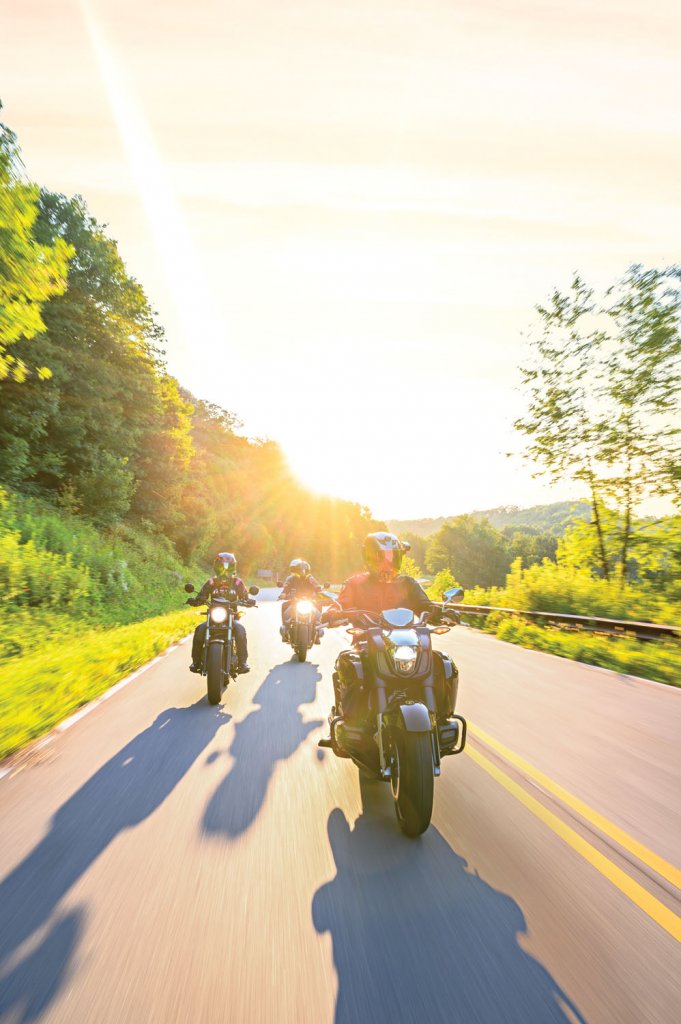 Three motorcyclists driving along the Cherohala Skyway near Robbinsville