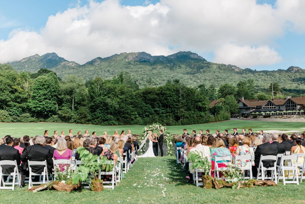 Blue skies, lush green mountains and a floral arbor provide the perfect backdrop to say “I do!” An aerial shot captures the club’s gorgeous grounds and lake.