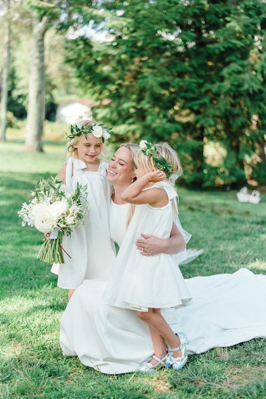 Flower girls in timeless white dresses and floral crowns.