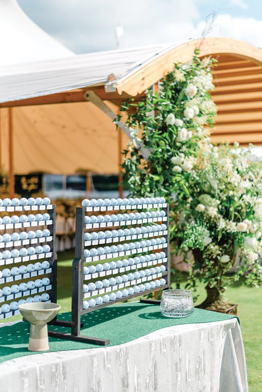 An aptly-placed golf ball seating chart helps guests find their place on the green.