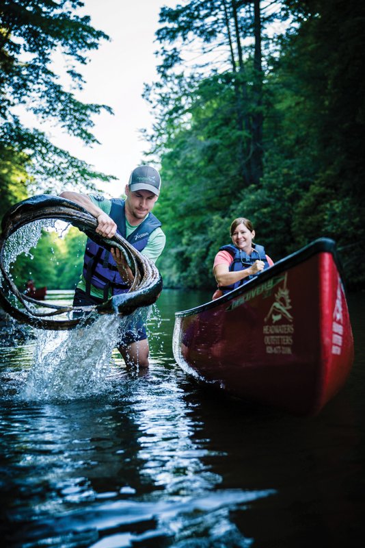 MountainTrue’s Jack Henderson pulls debris from the river.