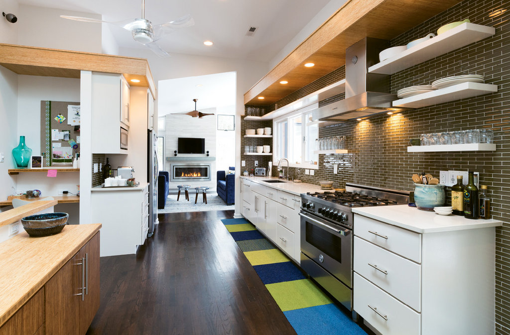 The kitchen is now bright and sleek thanks to skylights, a raised ceiling, and modern amenities.