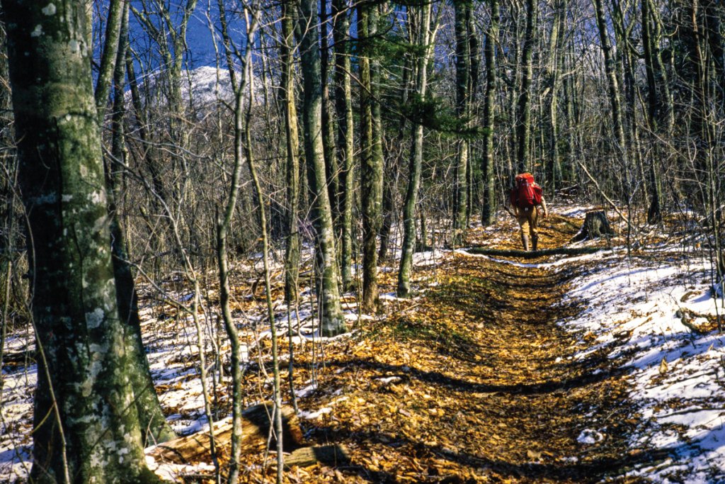 A November hiker aims at a high, snowy Calloway Peak.