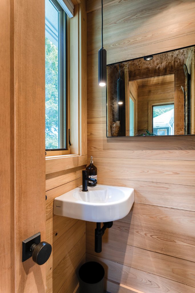 New + Natural - Flowing through the powder room are the same combination of natural finishes and modern fixtures installed throughout the home, maximizing space and feel.