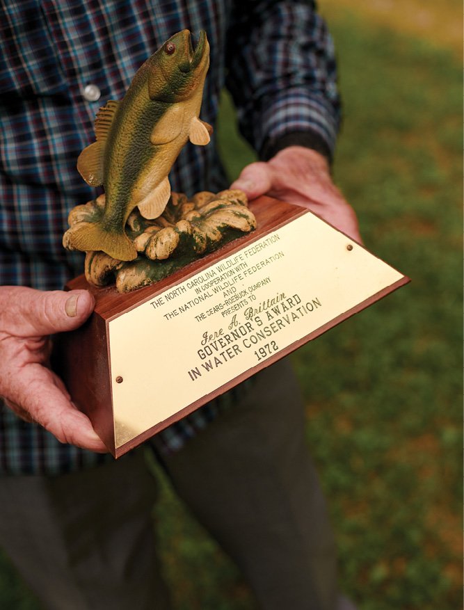 Here Brittain dusts off the North Carolina Wildlife Federation’s 1972 Governor’s Award in Water Conservation, which he received for his work combatting the TVA’s master plan for WNC.
