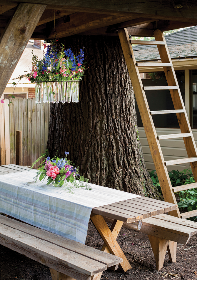 Underneath, a rustic picnic table is made elegant with blooms and a