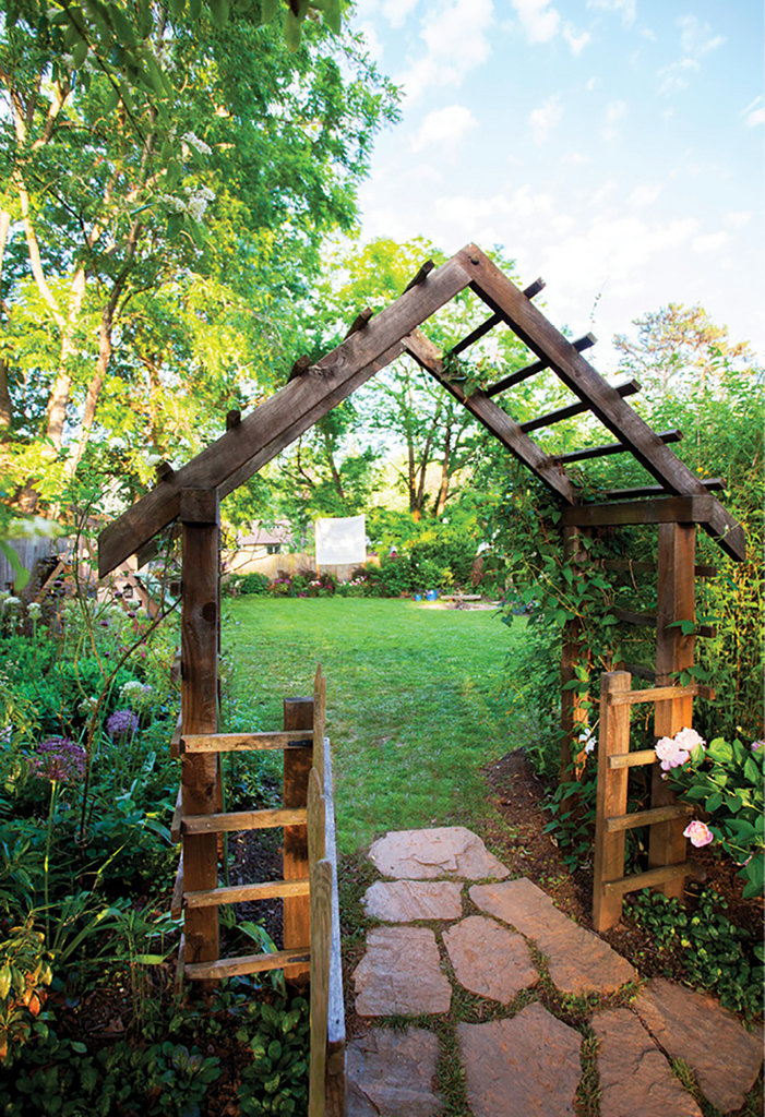 Entered via a wooden arbor, the backyard features an array of plants grown for Thomas’s shop, fairy and vegetable gardens.