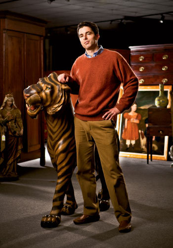 Andrew Brunk with an early 20th-century American carousel tiger up for auction March 12.