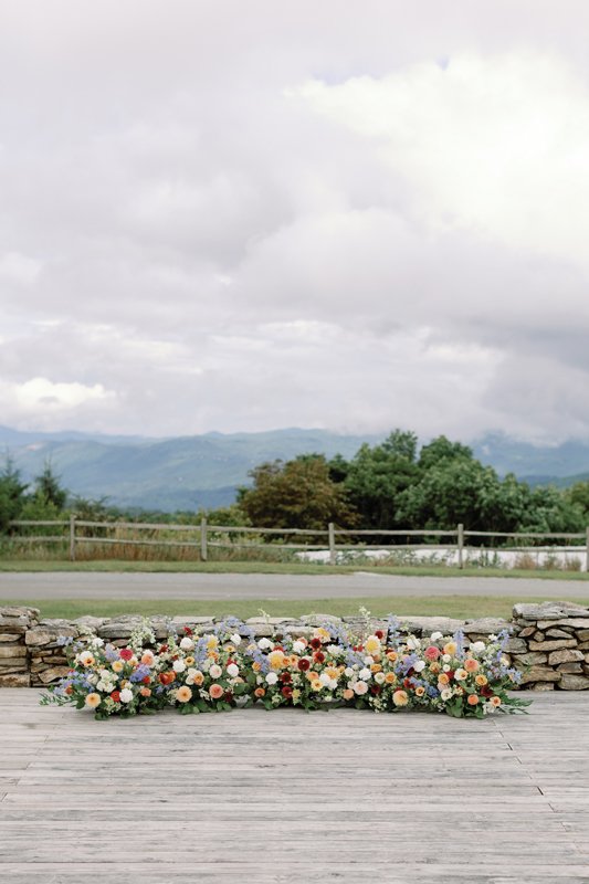 A ground installation allowed the ceremony florals to be repurposed for the reception sweetheart table.