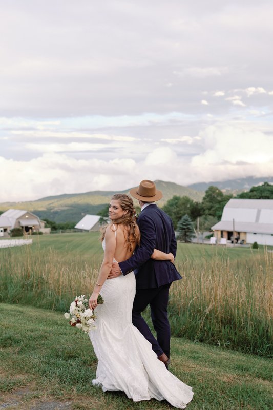 For their nuptials, Chesnut Smith wore a lace gown and loose up-down twist hairstyle, while Will Hagna sported a navy suit and caramel-hued fedora.