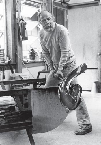 A Glass Act: Harvey uses gravity to help shape a form in his Spruce Pine Studio in 1982.
