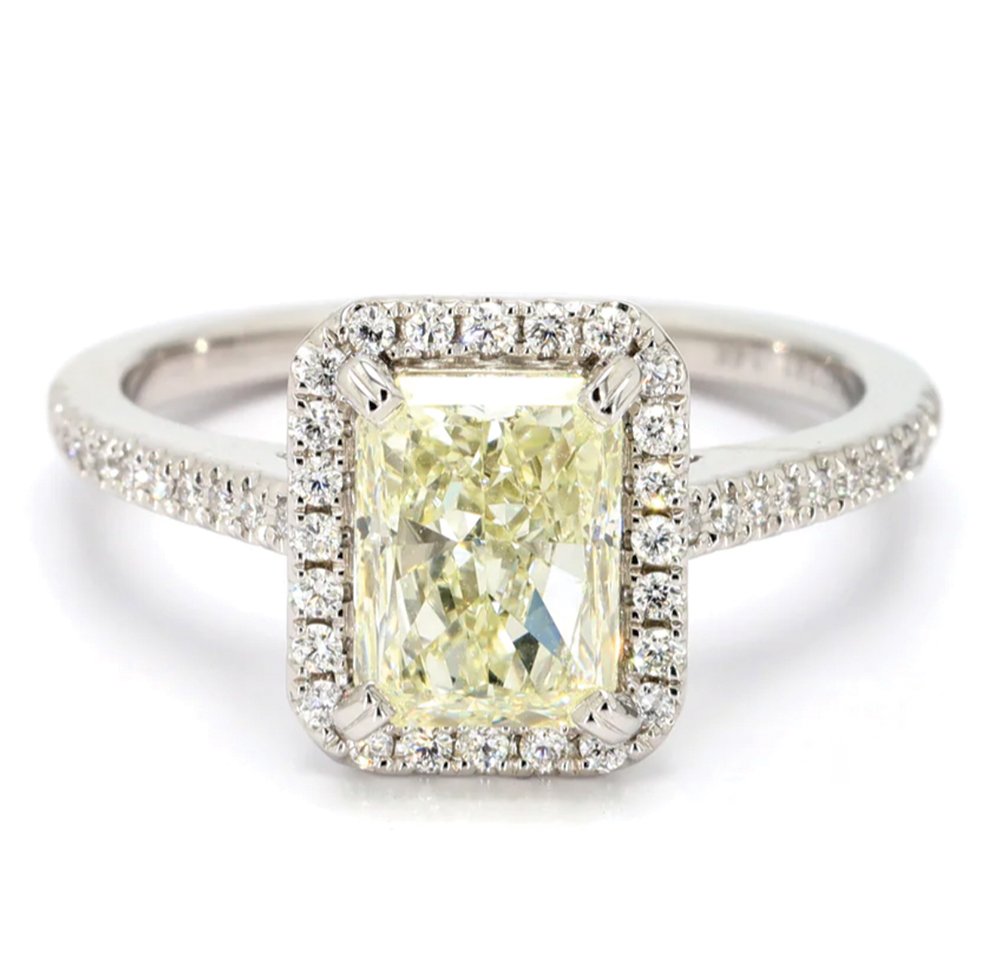 Radiantly Pretty - Halo Engagement Ring. 14 karat white gold with 2.01 carat radiant cut N SI1 diamond surrounded by 46 brilliant cut diamonds. $7,295. Spicer Greene, Asheville.spicergreene.com