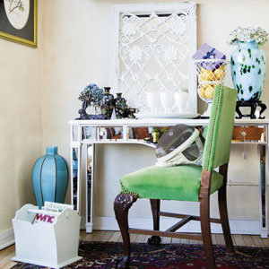 A mirrored desk and velvet upholstered chair create a charming office vignette.