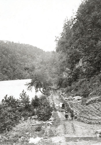 A circa-1880 photograph shows a stretch of the turnpike along the French Broad River to Warm Springs, current day Hot Springs.