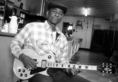 John Dee Holeman (April 4, 1929) Durham has long been a hotbed of North Carolina blues. John Dee spent most of his life there working construction and playing music on the side. His soulful music bridges the melodic Piedmont blues style and the grittier urban blues of the 1950s.