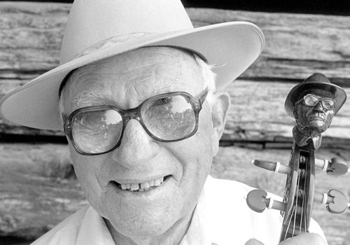 Frazier Moss (September 11, 1910-October 27, 1998) Living most of his life in Cookeville, Tennessee, Frazier won just about every fiddle contest around, including the National and Southeast fiddling championships and Tennessee Valley Old Time Fiddlers’ Association Championship. This photo captures Frazier’s playfulness. What it doesn’t tell you is what a fantastic fiddler he was. He played in a hard-driving, complex, yet swinging, style.