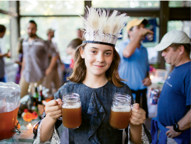Isabel Gray holds cider made from Green River Preserve apples.