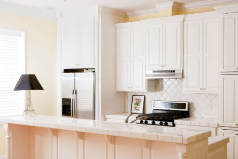 Custom ash cabinetry, crown molding, and tiles give the kitchen a 1930s look