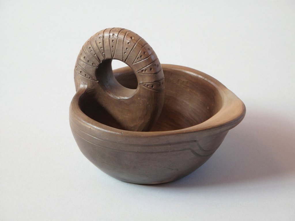 A pottery oil lamp made by Cora Wahneetah.