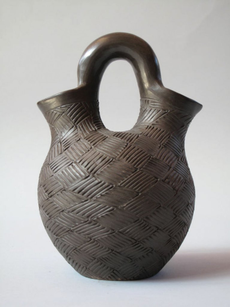 This 1961 double-spouted vase, also known as a wedding vase, was produced by self-taught Cherokee potter Rebecca “Amanda” Wolf Youngbird.